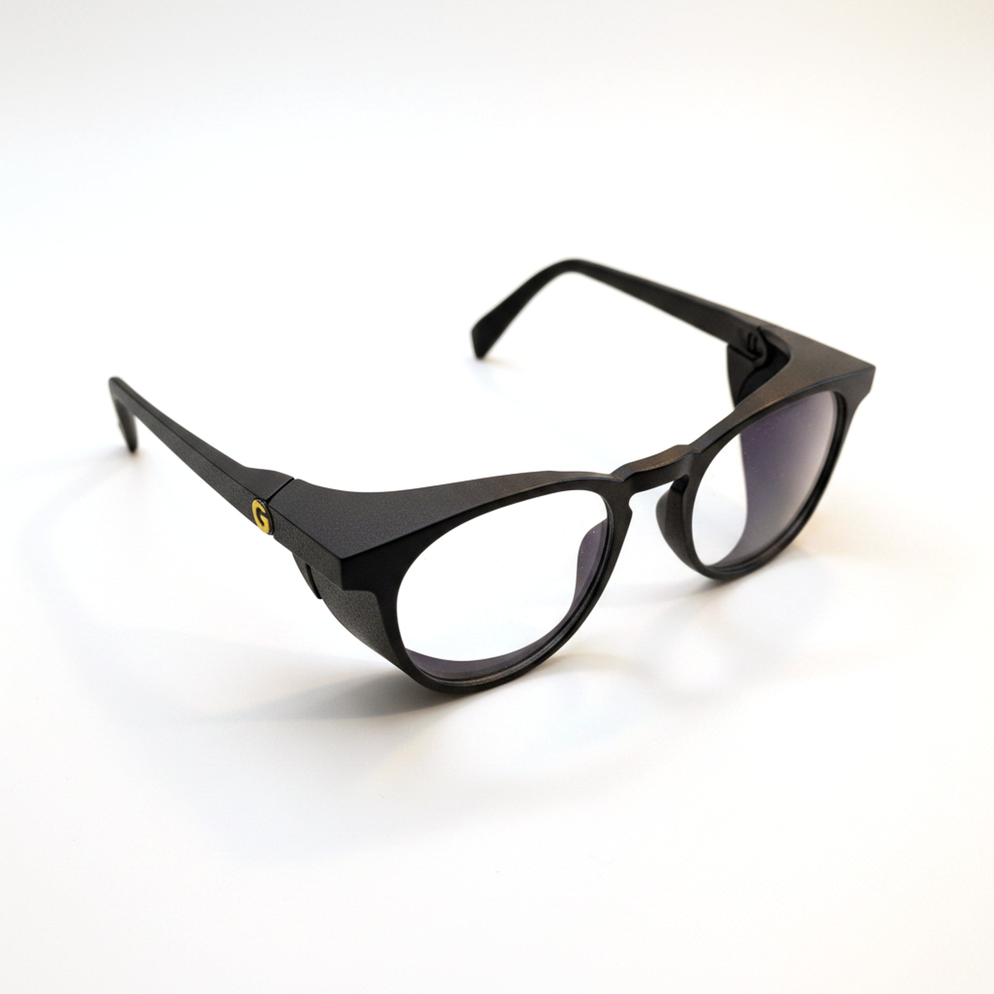 GOGHINI Focus Frames in three-quarter view, showing the matte black frame, side shields and gold G detail